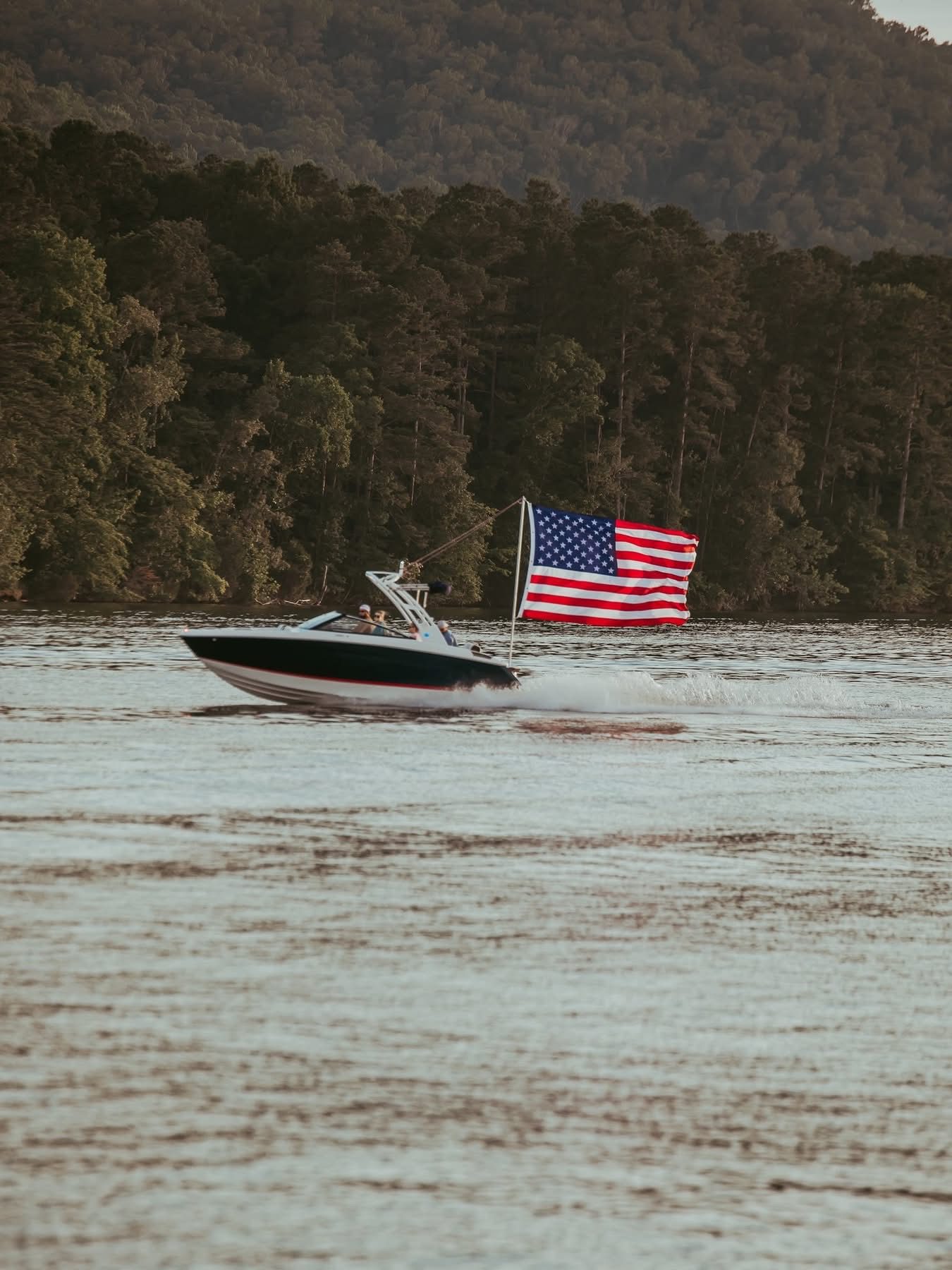 Boat flying the American flag on Lake Neely Henry