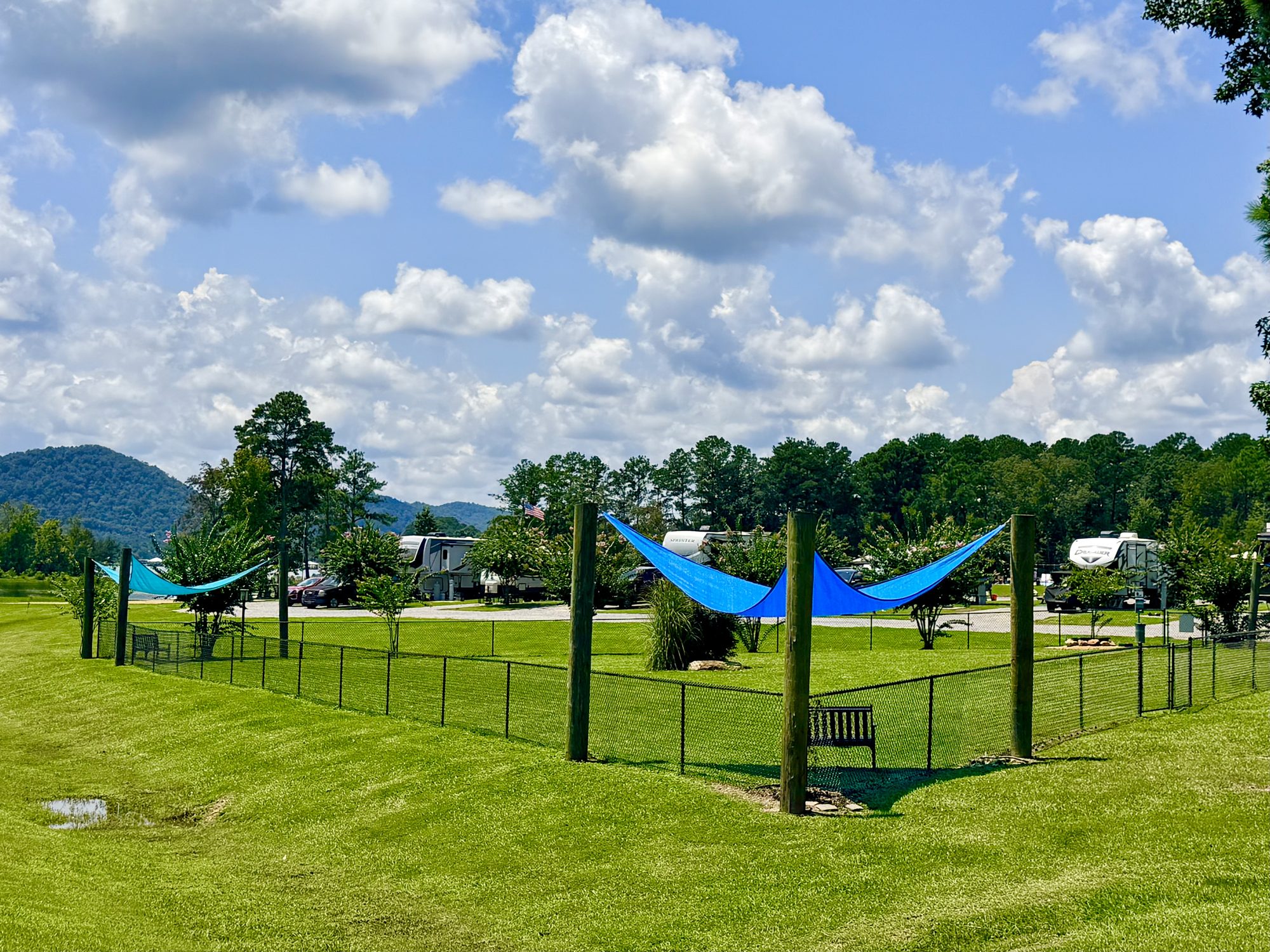 Shaded off-leash dog park at Greensport RV Park